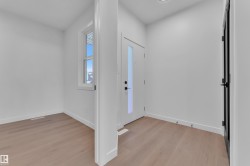 Foyer entrance featuring light wood-style floors and baseboards - 