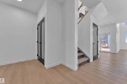 Corridor with light wood-type flooring and recessed lighting - 