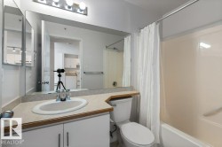 Bathroom featuring vanity and shower / bathtub combination with curtain - 
