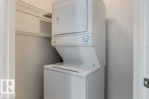 Laundry area featuring stacked washer / dryer - 403 14708 50 Street, Edmonton, AB - Indoor Photo Showing Laundry Room