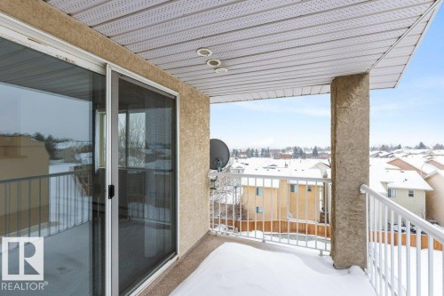 View of snow covered back of property - 403 14708 50 Street, Edmonton, AB - Outdoor With Balcony With Exterior