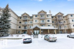 Snow covered building with a view of apartment building / complex - 
