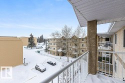 View of snow covered back of property - 