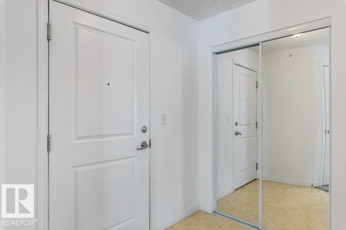 Foyer featuring a textured ceiling and light flooring - 403 14708 50 Street, Edmonton, AB - Indoor Photo Showing Other Room