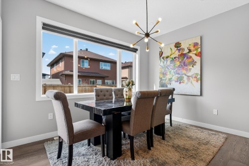 Dining space with hanging lights and wood finished floors - 1027 150 Avenue, Edmonton, AB - Indoor Photo Showing Dining Room