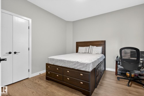 Bedroom with an office area and light wood-style flooring - 1027 150 Avenue, Edmonton, AB - Indoor Photo Showing Bedroom