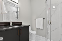 Full bathroom with vanity, a marble finish shower, and marble finish floors - 