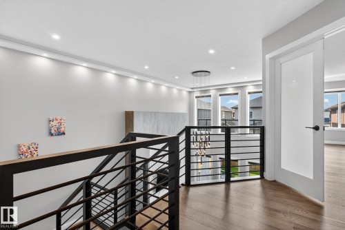 Hallway featuring an upstairs landing, hardwood / wood-style floors, plenty of natural light, and recessed lighting - 1027 150 Avenue, Edmonton, AB - Indoor Photo Showing Other Room