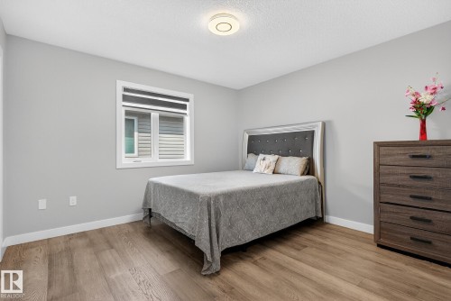 Bedroom featuring light wood-style flooring and a textured ceiling - 1027 150 Avenue, Edmonton, AB - Indoor Photo Showing Bedroom