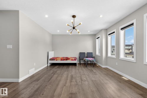 Sitting room with wood finished floors and suspended lighting - 1027 150 Avenue, Edmonton, AB - Indoor