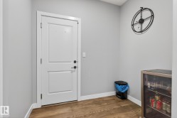 Doorway to outside featuring wood finished floors and baseboards - 