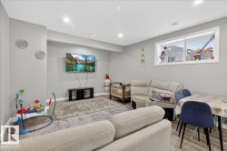 Bedroom featuring a crib, light wood-style floors, a textured ceiling, and a walk in closet - 