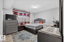 View of front of home featuring a shingled roof, driveway, an attached garage, and stone siding - 