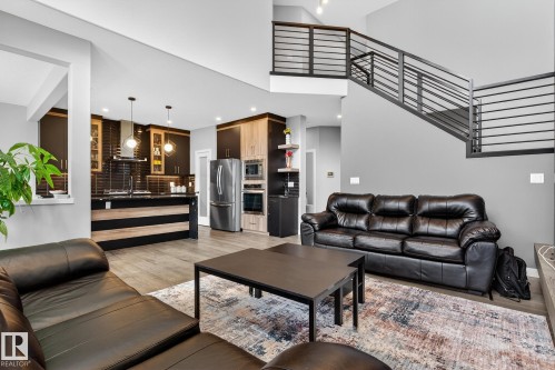 Living room with light wood-style floors, a high ceiling, and recessed lighting - 1027 150 Avenue, Edmonton, AB - Indoor Photo Showing Living Room