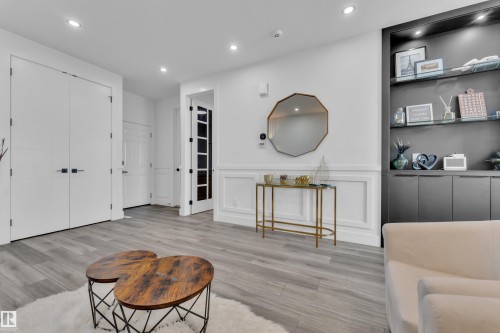 Sitting room featuring a decorative wall, recessed lighting, wainscoting, and light wood-type flooring - 316 42 Street, Edmonton, AB - Indoor Photo Showing Other Room