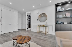 Sitting room featuring a decorative wall, recessed lighting, wainscoting, and light wood-type flooring - 