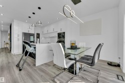 Dining area with light wood-style floors and recessed lighting - 