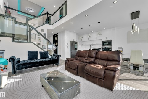 Living room with light wood-style floors, recessed lighting, and a high ceiling - 316 42 Street, Edmonton, AB - Indoor Photo Showing Living Room
