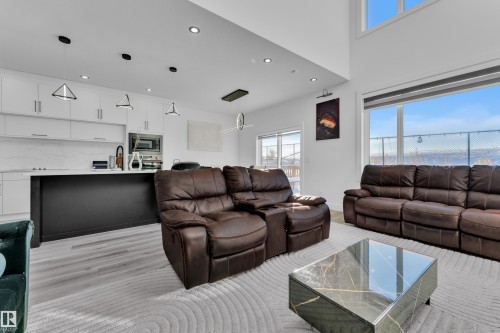 Living room with recessed lighting, light wood finished floors, and a high ceiling - 316 42 Street, Edmonton, AB - Indoor Photo Showing Living Room