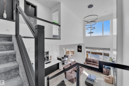 Living room with a high ceiling, wood finished floors, and recessed lighting - 316 42 Street, Edmonton, AB - Indoor Photo Showing Other Room
