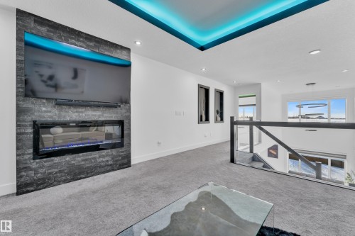 Unfurnished living room featuring carpet, a glass covered fireplace, and recessed lighting - 316 42 Street, Edmonton, AB - Indoor With Fireplace