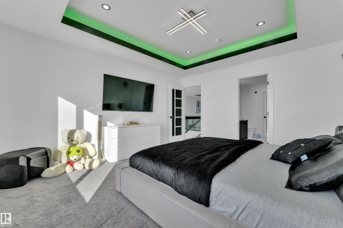 Carpeted bedroom with a tray ceiling, connected bathroom, and recessed lighting - 316 42 Street, Edmonton, AB - Indoor Photo Showing Bedroom