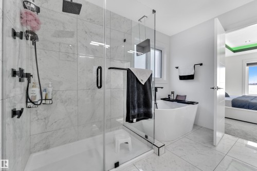 Full bathroom featuring ensuite bath, a freestanding bath, a marble finish shower, and marble finish floors - 316 42 Street, Edmonton, AB - Indoor Photo Showing Bathroom