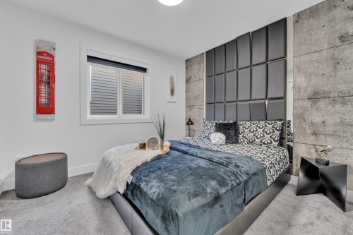 Carpeted bedroom with an accent wall and baseboards - 316 42 Street, Edmonton, AB - Indoor Photo Showing Bedroom