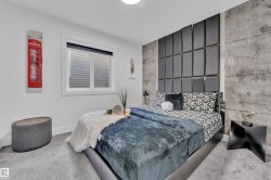 Carpeted bedroom with an accent wall and baseboards - 