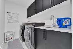 Laundry room with cabinet space and washer and clothes dryer - 
