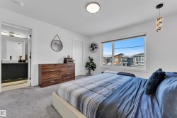 Carpeted bedroom featuring ensuite bath - 