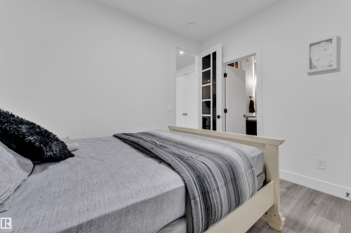 Bedroom featuring wood finished floors and ensuite bath - 316 42 Street, Edmonton, AB - Indoor Photo Showing Bedroom