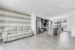 Living room with recessed lighting and an accent wall - 