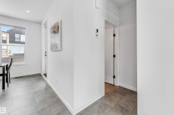 Hall featuring recessed lighting and light tile patterned flooring - 