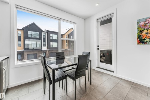Dining space with light tile patterned floors, wine cooler, and recessed lighting - 77 5 Rondeau Drive, St. Albert, AB - Indoor Photo Showing Dining Room