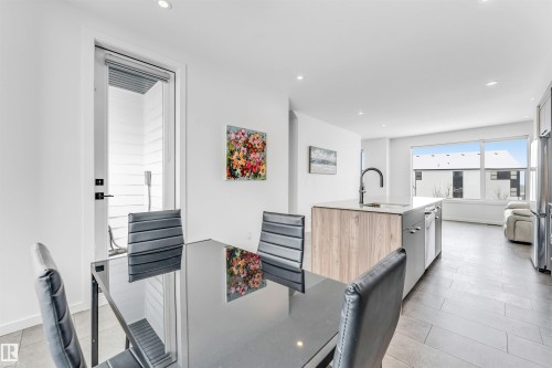 Kitchen featuring recessed lighting, light wood finish cabinetry, freestanding refrigerator, modern cabinets, and light tile patterned floors - 77 5 Rondeau Drive, St. Albert, AB - Indoor