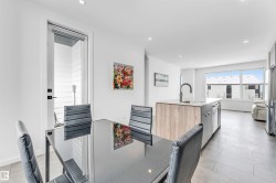 Kitchen featuring recessed lighting, light wood finish cabinetry, freestanding refrigerator, modern cabinets, and light tile patterned floors - 