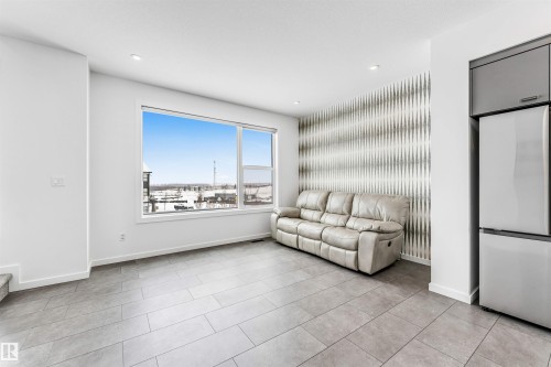 Living area featuring an accent wall and recessed lighting - 77 5 Rondeau Drive, St. Albert, AB - Indoor