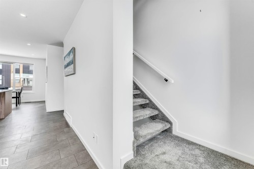 Stairway with baseboards and recessed lighting - 77 5 Rondeau Drive, St. Albert, AB - Indoor Photo Showing Other Room