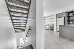 Staircase with tile patterned floors and recessed lighting - 