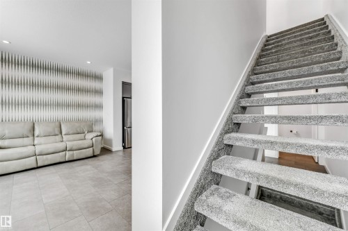 Staircase featuring recessed lighting and an accent wall - 77 5 Rondeau Drive, St. Albert, AB - Indoor Photo Showing Other Room