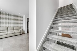 Staircase featuring recessed lighting and an accent wall - 