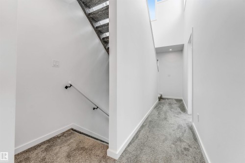 Stairs with carpet floors and a high ceiling - 77 5 Rondeau Drive, St. Albert, AB - Indoor Photo Showing Other Room