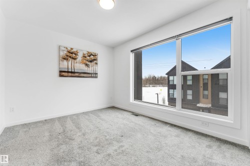 Carpeted empty room featuring baseboards - 77 5 Rondeau Drive, St. Albert, AB - Indoor Photo Showing Other Room