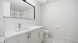 Full bathroom featuring vanity, a shower stall, and light tile patterned floors - 