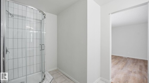 Full bath featuring a shower stall and light tile patterned floors - 3419 143 Avenue Nw, Edmonton, AB - Indoor