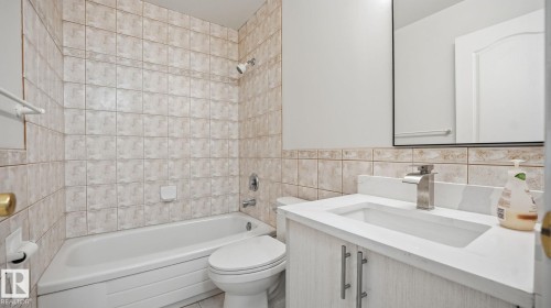 Full bathroom featuring tile walls, bathing tub / shower combination, and vanity - 3419 143 Avenue Nw, Edmonton, AB - Indoor Photo Showing Bathroom