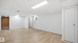 Finished basement featuring light wood-type flooring and baseboards - 