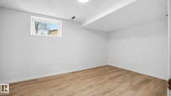 Bonus room featuring light wood-type flooring and a textured ceiling - 