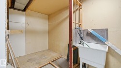 Miscellaneous room featuring unfinished concrete floors and a sink - 